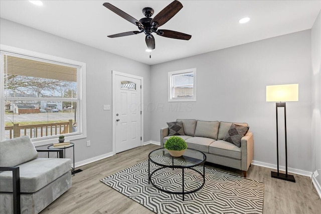 living room with ceiling fan and light hardwood / wood-style floors