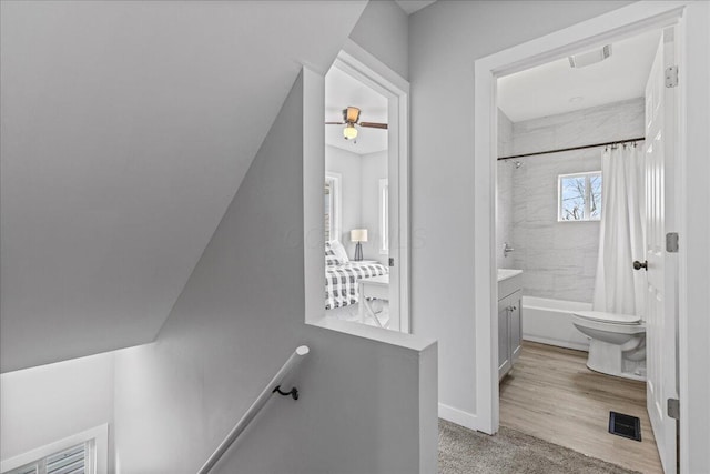 full bathroom featuring vanity, shower / tub combo, and toilet