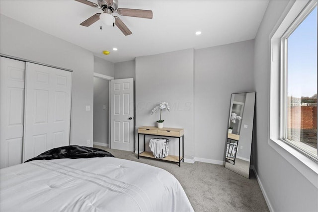 carpeted bedroom with a closet and ceiling fan