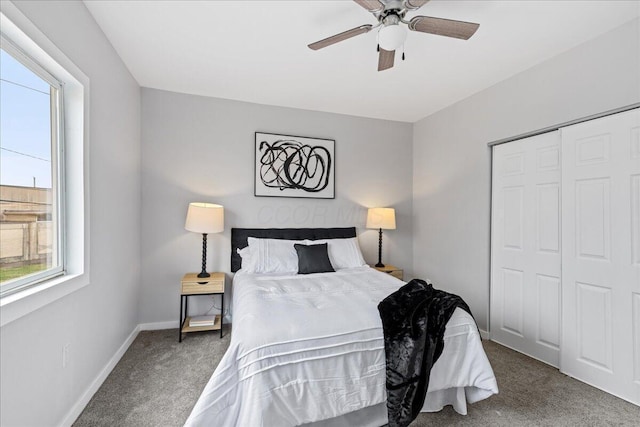 carpeted bedroom with ceiling fan and a closet