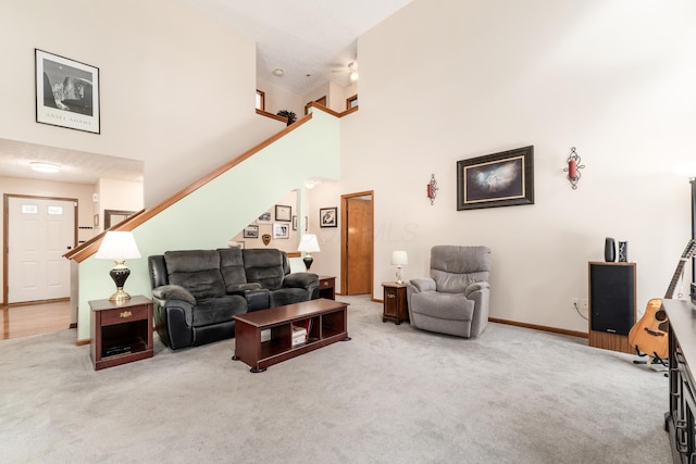 living room featuring carpet flooring and a high ceiling