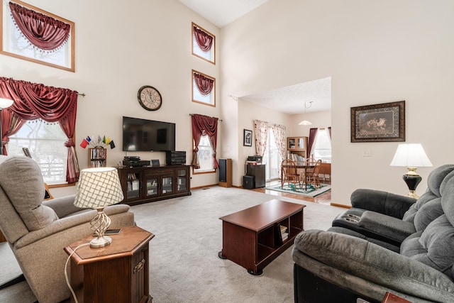 carpeted living room featuring a high ceiling