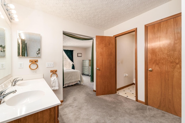 bathroom featuring vanity, toilet, and a textured ceiling