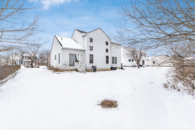 view of snow covered back of property