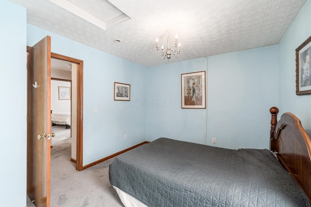 carpeted bedroom with a textured ceiling and an inviting chandelier