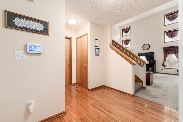 entryway featuring a textured ceiling and light hardwood / wood-style flooring