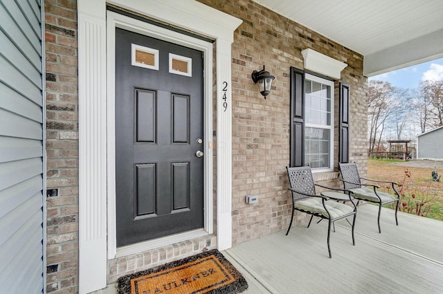 doorway to property featuring covered porch