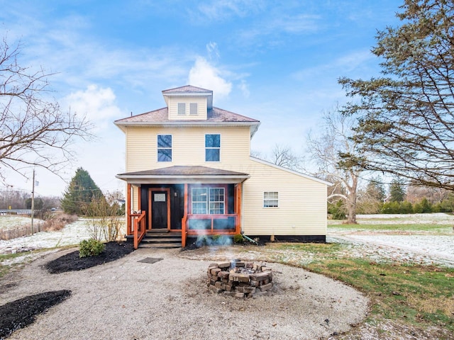 rear view of house featuring a fire pit