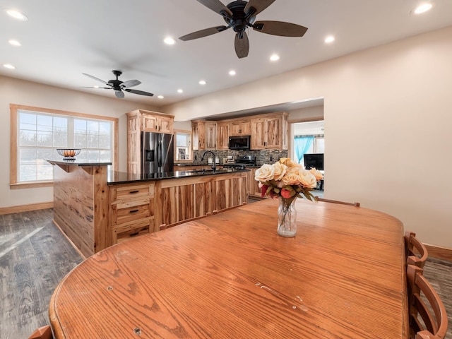 dining space with sink, light hardwood / wood-style floors, and ceiling fan