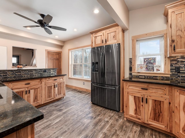 kitchen featuring ceiling fan, dark hardwood / wood-style floors, stainless steel refrigerator with ice dispenser, and tasteful backsplash