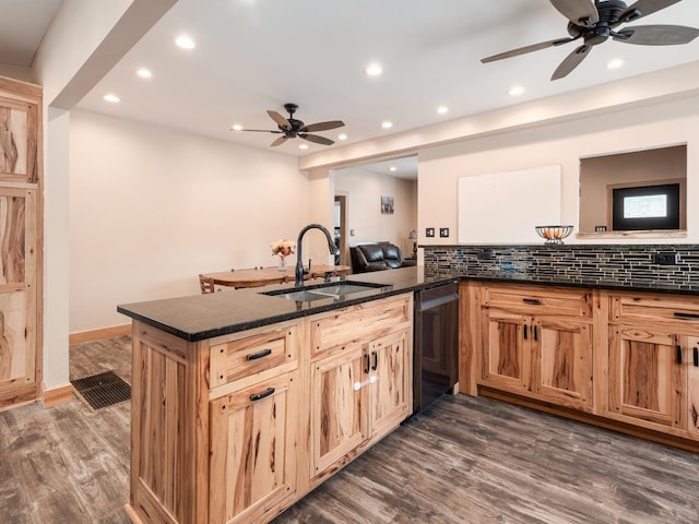 kitchen featuring kitchen peninsula, sink, dark hardwood / wood-style floors, and black dishwasher