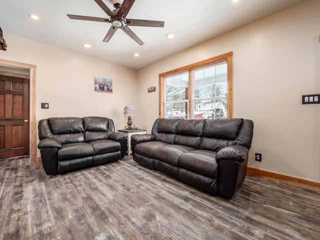 living room featuring ceiling fan and dark hardwood / wood-style flooring