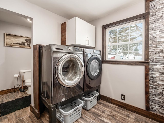 washroom with dark hardwood / wood-style floors, cabinets, and washer and dryer