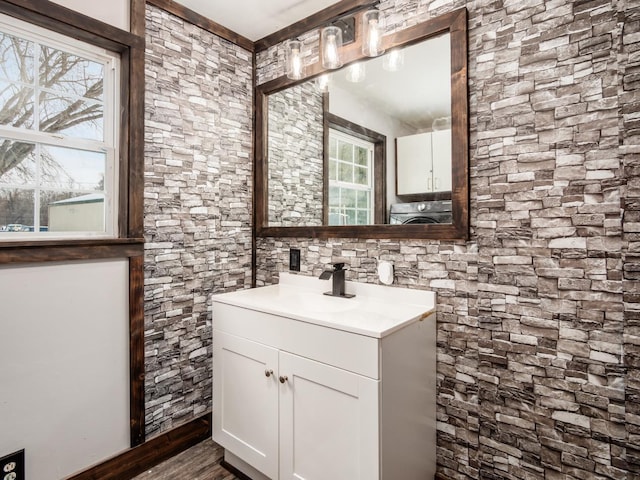 bathroom with washer / clothes dryer and vanity