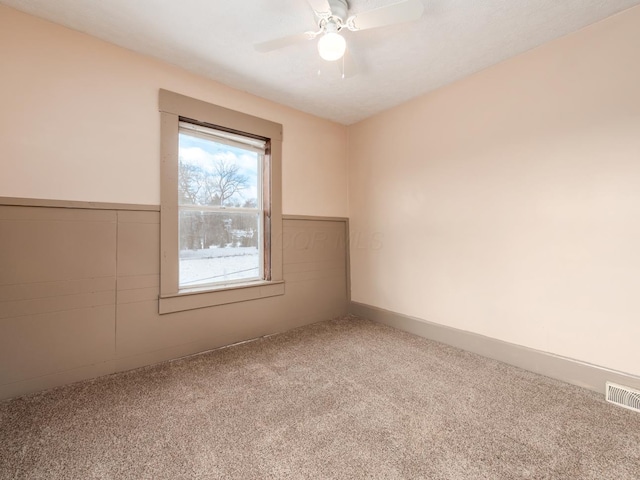 empty room with ceiling fan and carpet flooring