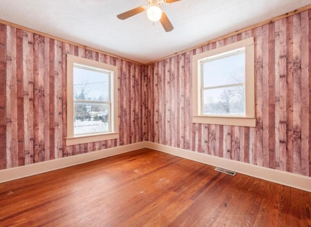 spare room featuring hardwood / wood-style flooring and ceiling fan