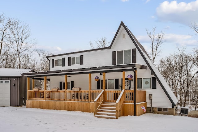 view of front of house featuring a porch, cooling unit, an outdoor structure, and a garage