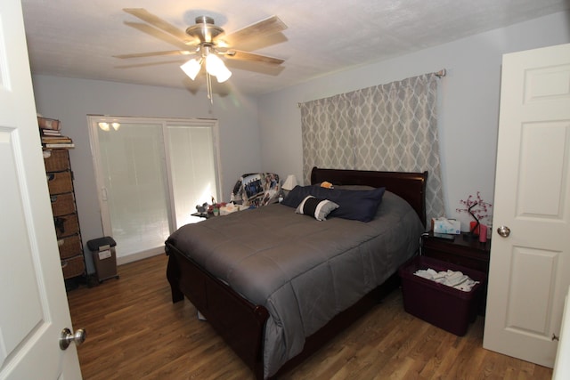 bedroom with dark hardwood / wood-style flooring and ceiling fan