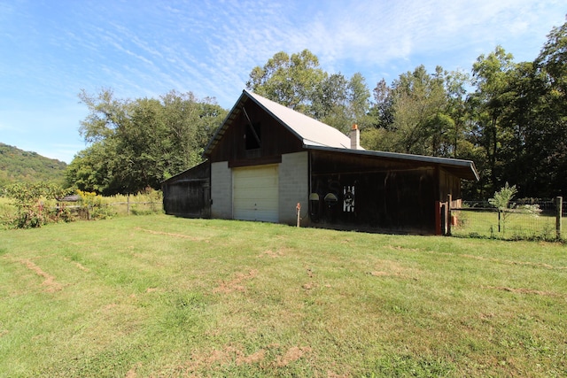 view of outbuilding with a yard