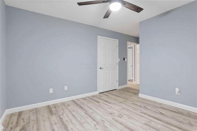 spare room featuring ceiling fan and light wood-type flooring