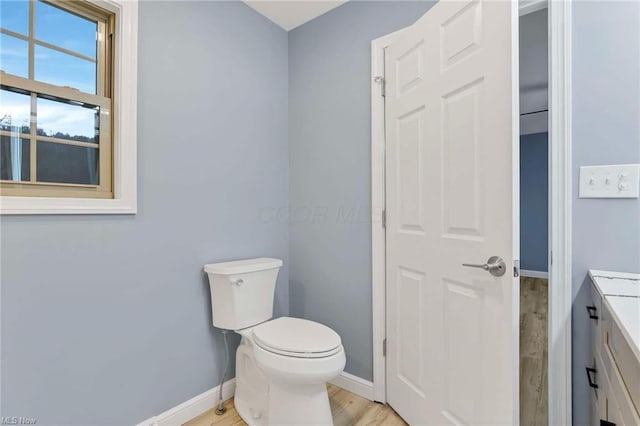 bathroom featuring hardwood / wood-style floors, vanity, and toilet