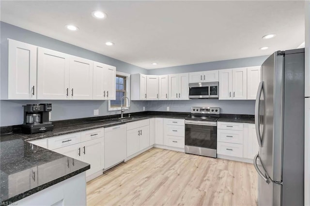 kitchen with white cabinets and appliances with stainless steel finishes