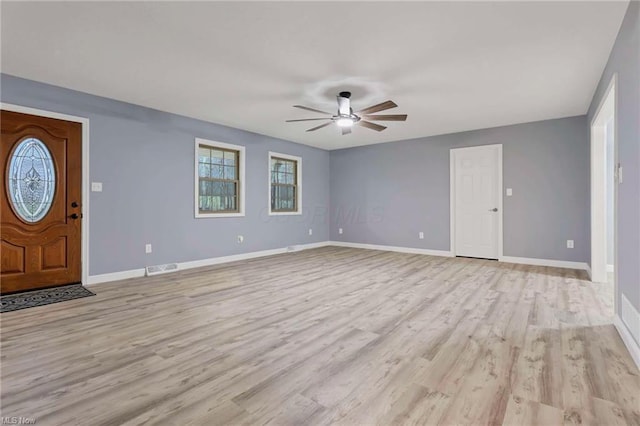 foyer with light hardwood / wood-style floors and ceiling fan