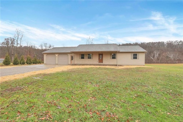 ranch-style home with a garage and a front lawn