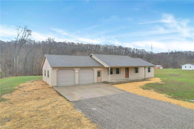 ranch-style house with a garage and a front lawn