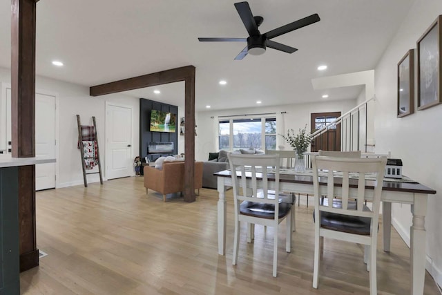 dining area featuring light wood-type flooring and ceiling fan