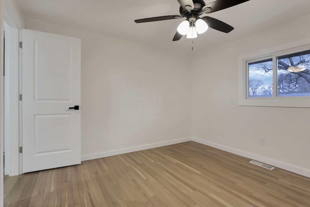 empty room featuring light wood-type flooring and ceiling fan