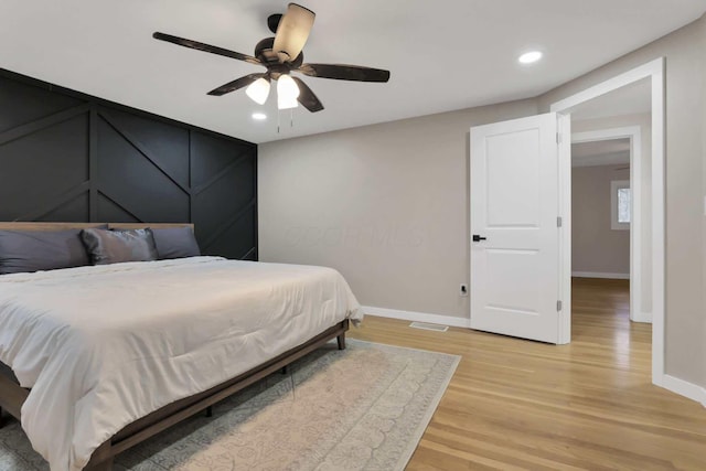 bedroom with ceiling fan and light hardwood / wood-style floors