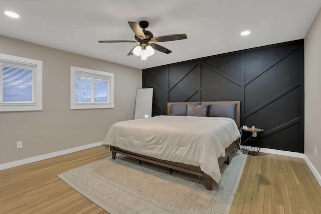 bedroom with ceiling fan and light wood-type flooring