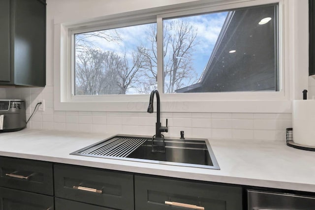 kitchen with dishwasher, backsplash, a healthy amount of sunlight, and sink