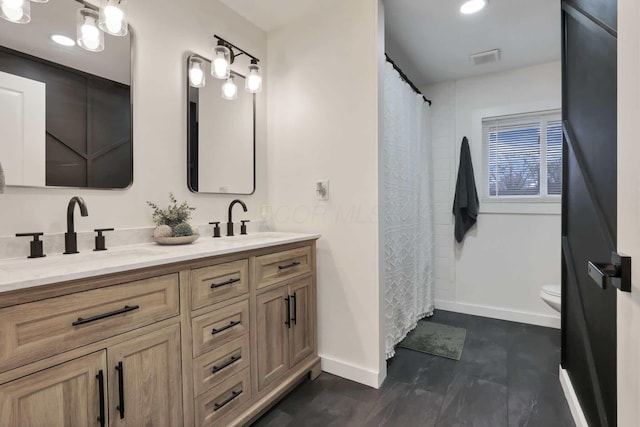 bathroom with vanity and toilet