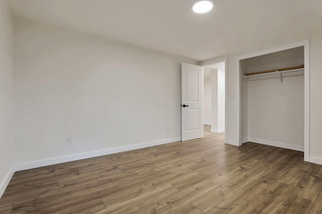 unfurnished bedroom featuring a closet and wood-type flooring