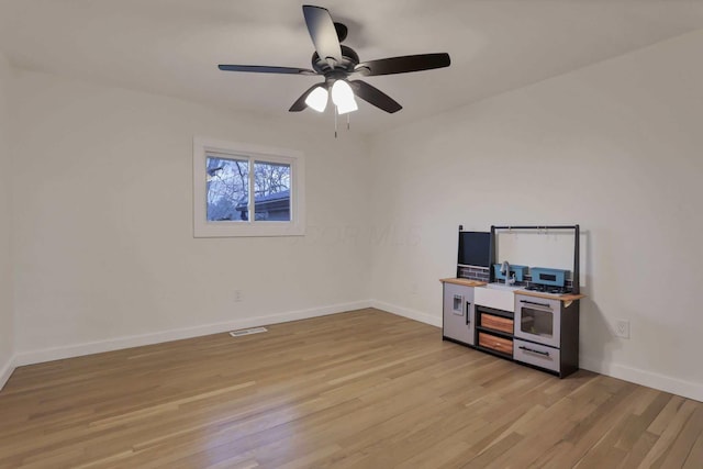 home office featuring ceiling fan and light hardwood / wood-style flooring