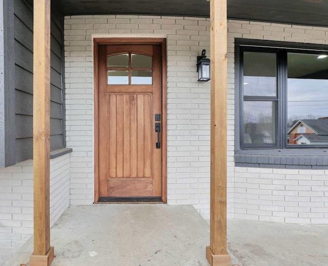 view of exterior entry with covered porch