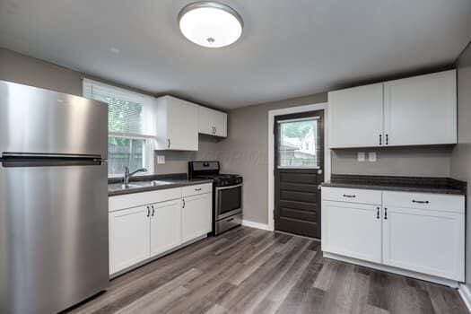 kitchen featuring sink, white cabinets, and stainless steel appliances