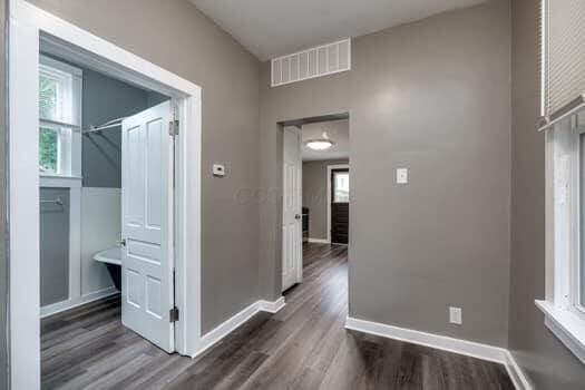 hall with dark wood-type flooring