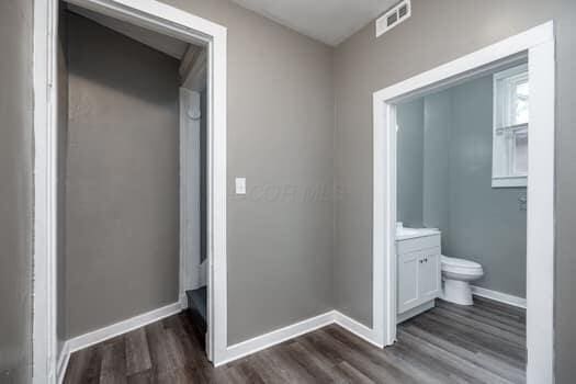 bathroom with vanity, hardwood / wood-style flooring, and toilet