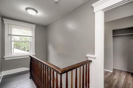 hallway with dark hardwood / wood-style flooring