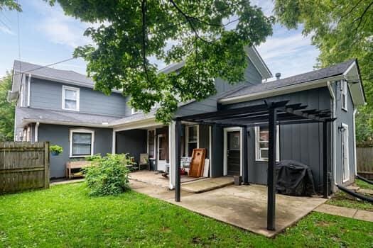 rear view of house with a yard and a patio