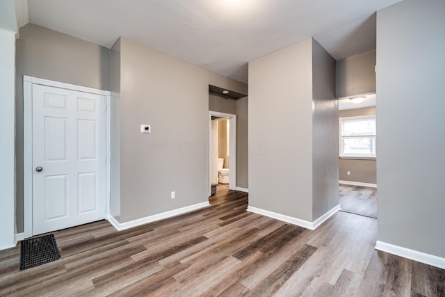 spare room featuring wood-type flooring