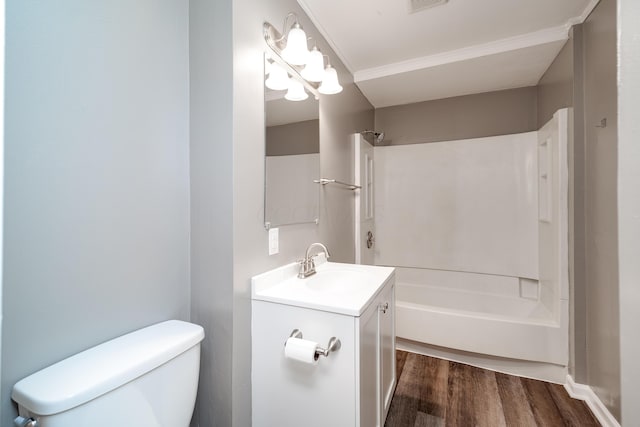 full bathroom with bathtub / shower combination, hardwood / wood-style floors, vanity, and toilet