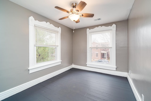 empty room featuring dark hardwood / wood-style floors and ceiling fan