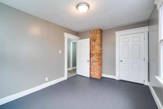 unfurnished bedroom with dark hardwood / wood-style floors