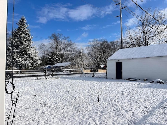 yard covered in snow with an outdoor structure