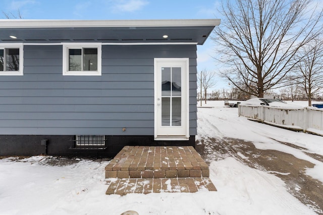 view of snow covered property entrance