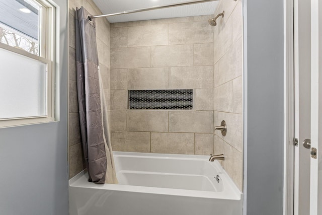 bathroom with shower / bath combo with shower curtain